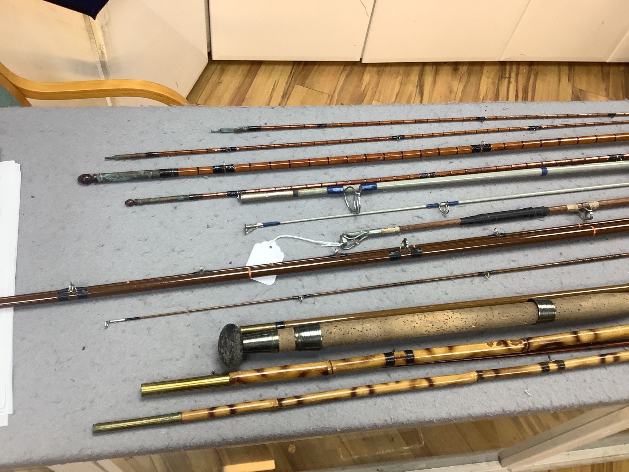 A quantity of fishing rods in fabric sleeves (6)